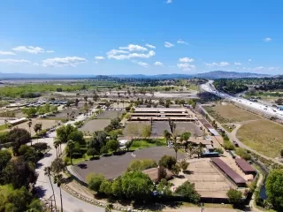 an aerial view of a parking lot and a highway