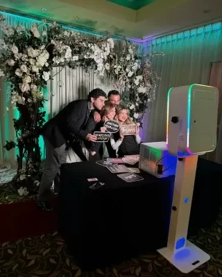 captura events photo booth with flower arch backdrop