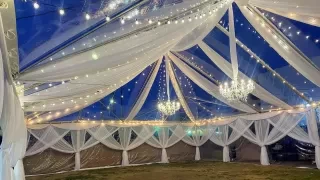 a large tent with a chandelier and lights