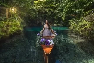a woman in a wedding dress on a boat