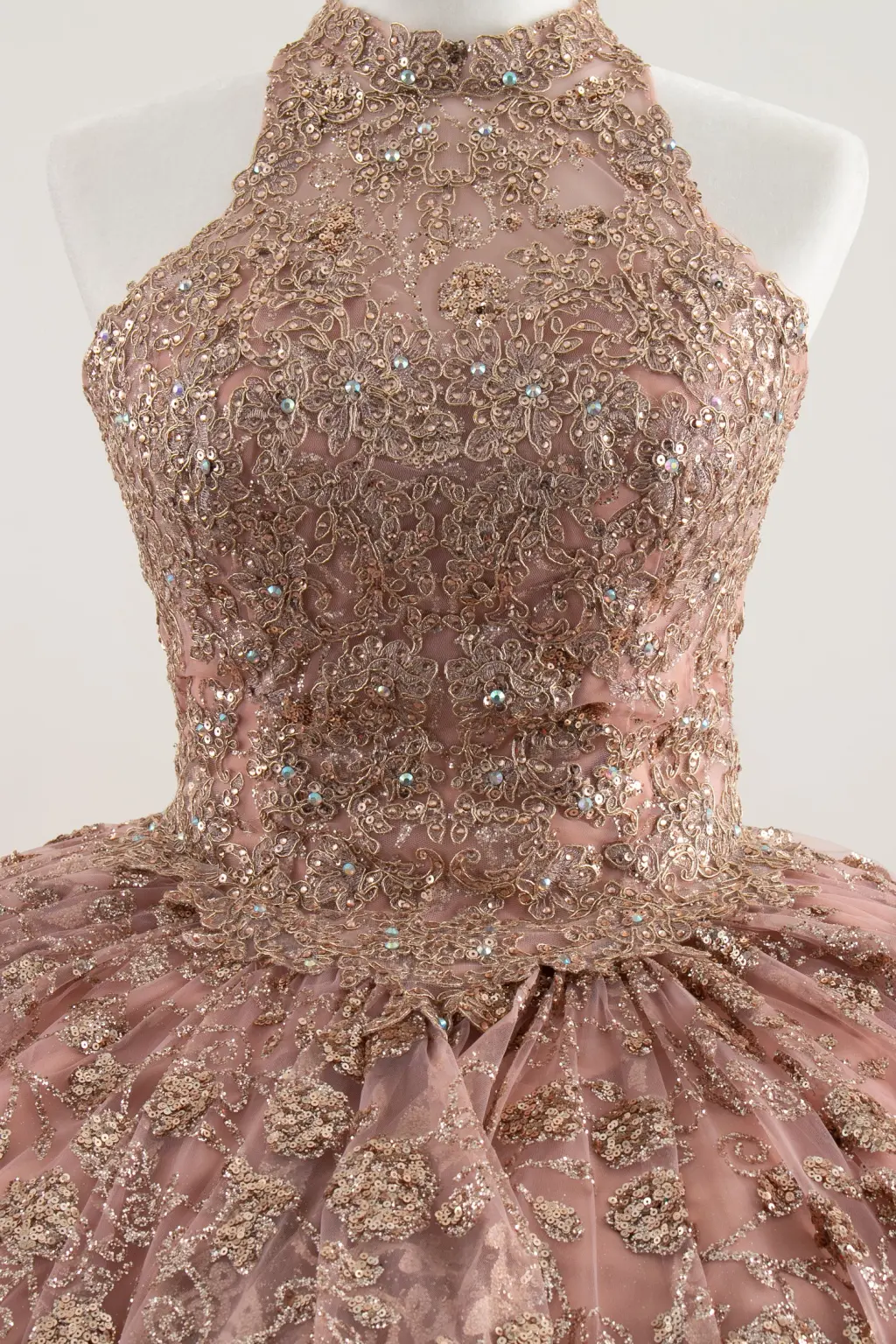 Blush pink sleeveless quinceañera dress with lace appliqués and a voluminous ball gown skirt -1