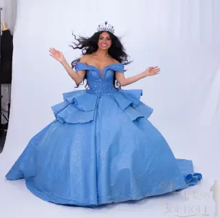 A custom blue quinceañera dress with off-the-shoulder neckline, sweetheart bodice, and ruffled ball gown skirt with a flowing train - 6