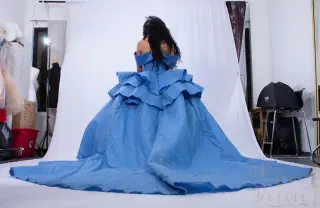 A custom blue quinceañera dress with off-the-shoulder neckline, sweetheart bodice, and ruffled ball gown skirt with a flowing train - 3