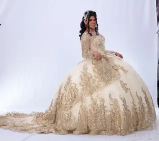 Gold quinceañera dress with sweetheart neckline, sheer long sleeves, and a voluminous ball gown skirt with lace appliqués -4
