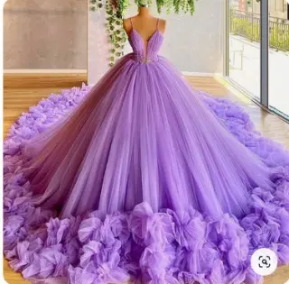 Purple sleeveless quinceañera dress with a V-neckline, voluminous tulle skirt, and ruffled train.