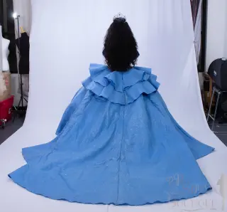 A custom blue quinceañera dress with off-the-shoulder neckline, sweetheart bodice, and ruffled ball gown skirt with a flowing train - 2